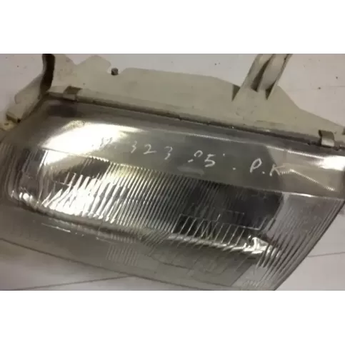 082161126M фара передняя Mazda 323 1995